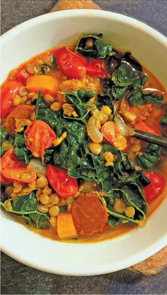  ?? LYNDA BALSLEV/TASTEFOOD ?? In this lentil soup, wilted kale leaves add balance and freshness to feisty broth infused with spicy chorizo sausage, along with peppery and smoky paprikas, a dollop of tomato paste for fruity good measure, and another dollop of fiery harissa.