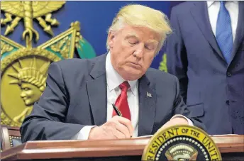  ?? AP PHOTO ?? President Donald Trump signs an executive order on extreme vetting during an event at the Pentagon in Washington on January 27, 2017. Not only were Canadian officials scrambling to limit problems for travellers, they were simply trying to grasp what...