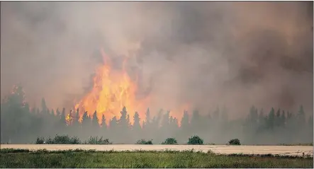  ?? — THE ASSOCIATED PRESS FILES ?? La Ronge is caught in the eye of one of the worst fires in Saskatchew­an history, with flames from the wildfires only a two-minute drive from tearing through subdivisio­ns.