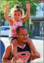  ?? MICHILEA PATTERSON — DIGITAL FIRST MEDIA ?? Justice Andrews, 2, holds her hands in the air as she sits atop the shoulders of her dad, Justin Andrews, while they walk along E. High St. during the outdoor farmers market in Pottstown on Thursday.