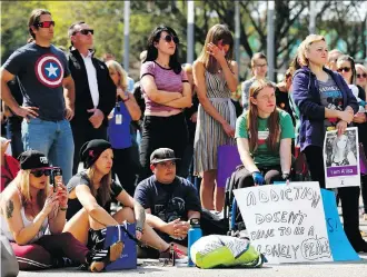  ?? PHOTOS: DARREN MAKOWICHUK ?? Dozens came out Friday for Internatio­nal Overdose Awareness Day at City Hall. Calgary continues to lose hundreds of people each year to drugs, with fentanyl being particular­ly lethal.