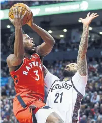  ?? VAUGHN RIDLEY GETTY IMAGES ?? The Raptors’ OG Anunoby takes a shot against the Nets’ Wilson Chandler at Scotiabank Arena on Saturday.