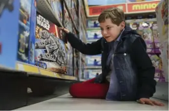  ?? RICHARD LAUTENS/TORONTO STAR ?? Toy tester Alex Thorne, 13, looks at one of his top picks, Lego’s Millennium Falcon.