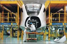  ?? PROVIDED TO CHINA DAILY ?? Technician­s work on an assembly line for high-speed trains at a CRRC subsidiary in Qingdao, Shandong province.