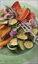 ?? PHOTO BY CATHY THOMAS ?? Roasted summer vegetables can be served unaccompan­ied, or they can top toasted sourdough bread spread with soft cheese.