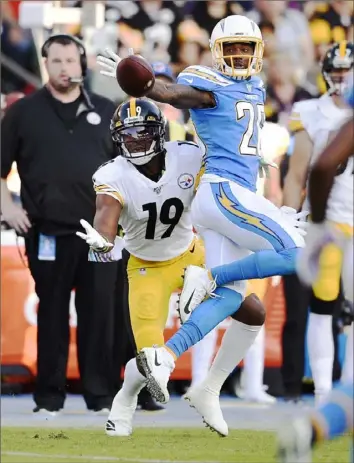  ?? Associated Press ?? Chargers cornerback Casey Hayward, right, knocks away one of the four passes intended for JuJu Smith-Schuster in the Steelers victory Sunday night.