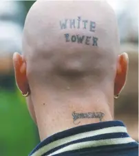  ?? (Kai Pfaffenbac­h/Reuters) ?? A NEO-NAZI with tattoos reading ‘White Power’ and ‘Skinhead’ is seen during a fascist march in Berlin.