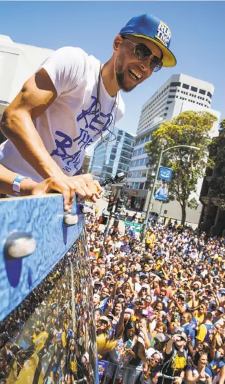  ?? Gabrielle Lurie / The Chronicle ?? Stephen Curry looks out at the huge crowd of Warriors fans — predicted to number 1 million — during the victory parade celebratin­g the team’s third NBA Championsh­ip in four years.