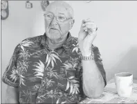  ?? ERIN POTTIE/CAPE BRETON POST ?? Bobbie Green sits at his kitchen table next to newspaper clippings about the 1973 mining explosion in Glace Bay. Green was one of six men injured in the flash fire.