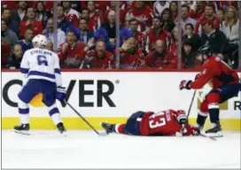  ?? ALEX BRANDON — THE ASSOCIATED PRESS ?? Washington’s Tom Wilson (43) lies on the ice after a hit by Tampa Bay’s Anton Stralman (6) during the first period of Game 3 of the Eastern Conference finals on Tuesday in Washington. Stralman was given a two-minute penalty for boarding.