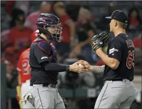  ?? MARK J. TERRILL — THE ASSOCIATED PRESS ?? Roberto Perez, left, and starting pitcher Zach Plesac congratula­te each other after the Angels’ Matt Thaiss struck out to end the game Sept. 10 in Anaheim, Calif.