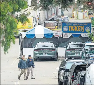  ??  ?? FBI personnel pass a ticket booth at the Gilroy Garlic Festival Monday in California, the morning after a gunman killed at least three people, including a 6-year-old boy, and wounded about 15 others. A law enforcemen­t official identified the gunman, who was shot and killed by police, as Santino William Legan. [NOAH BERGER/ THE ASSOCIATED PRESS]