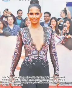  ??  ?? Halle Berry arrives at the premiere of the film ‘Kings’ at Toronto Internatio­nal Film Festival (TIFF) in Toronto on Wednesday. Halle Berry stars as Millie, a hardworkin­g single mother trying to keep her children and strays safe during the LA riots.—...