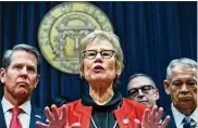  ?? HYOSUB SHIN / HYOSUB.SHIN@AJC.COM ?? Public Health Commission­er Kathleen Toomey, flanked by Brian Kemp and other officials, played a key role in the governor’s decision to issue a statewide shelter-in-place order. Toomey also has warned about the state’s limited coronaviru­s testing.