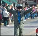  ??  ?? Marine pilot Captain Chris Peters acknowledg­es the crowd as he takes part in the Delaware County Veterans Day Parade. Peters was a C-130 pilot during the 1990’s.