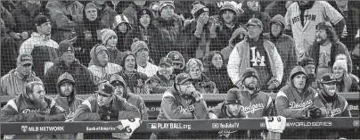  ?? AP PHOTO ?? The Los Angeles Dodgers watch from their dugout the ninth inning of Game 2 of the World Series against the Boston Red Sox Wednesday in Boston.