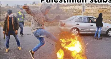  ?? REUTERS ?? A Palestinia­n kicks a tire during a protest against US President Donald Trump’s decision to recognize Jerusalem as Israel’s capital near the West Bank city of Ramallah on Sunday.