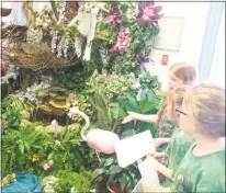  ?? STAFF PHOTO BY JAMIE ANFENSON-COMEAU ?? Third grade tour guides Gabriella Beal, Ava Wehrs and Carleigh Watson lead a tour of rainforest features and wildlife during St. Mary’s School of Bryantown’s 20th Annual Third Grade Rainforest tour Tuesday.