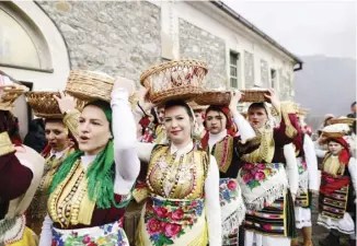  ?? ROBERT ATANASOVSK­I/AGENCE FRANCE-PRESSE ?? WOMEN dressed in traditiona­l folk costumes participat­e at the Epiphany day celebratio­ns in the village of Bitushe, some 50 kilometers southwest of Gostivar, North Macedonia.