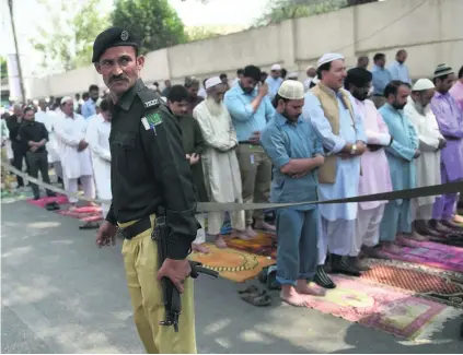  ?? Rizwan Tabassum / AFP ?? Protection was enhanced in Karachi after the attack on the Sufi shrine, which worshipper­s say was neglected by police.