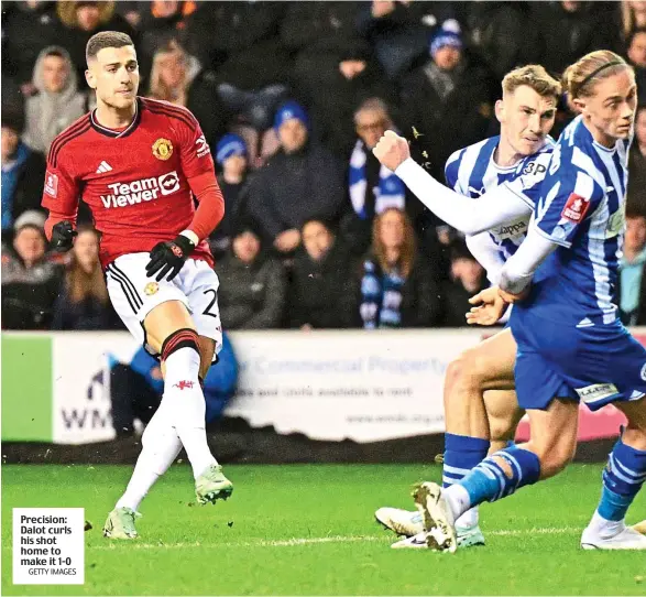  ?? GETTY IMAGES ?? Precision: Dalot curls his shot home to make it 1-0