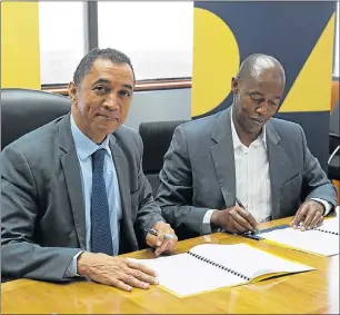  ??  ?? JOINING FORCES: Outgoing NMU vice-chancellor Professor Derrick Swartz, left, signed a memorandum of understand­ing with ECDC chief executive Ndzondelel­o Dlulane