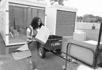  ??  ?? UPS seasonal helper Gretchen Castro, 52, loads a golf cart before making deliveries.