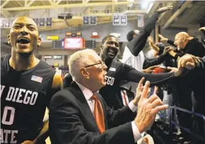  ?? JED CONKLIN AP ?? Then SDSU-head coach Steve Fisher talks to fans after their win at Gonzaga’s McCarthey Athletic Center in 2010. The all-time series between the teams is tied at 2-2.