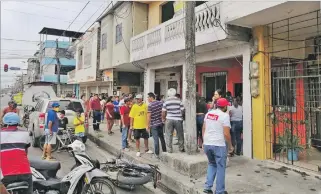  ?? TATIANA ORTIZ / EXPRESO ?? Babahoyo. Vecinos y curiosos se aglomeran frente a la casa donde le dispararon a Freddy Collaguazo.