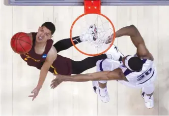  ?? | GETTY IMAGES ?? Loyola’s Lucas Williamson shoots over Kansas State’s Xavier Sneed on Saturday.