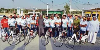  ?? Ahmed Kutty/Gulf News ?? Shaikh Tayyeb Bin Khalifa Bin Hamdan Al Nahyan (5th from right, front row) with other riders after the opening of the two new bike-sharing stations under Cyacle near Masdar.