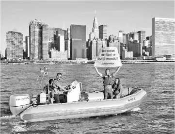  ??  ?? Greenpeace activists hold up a banner near the United Nations to draw attention the global ocean sanctuarie­s campaign in the East River in New York. — AFP photo