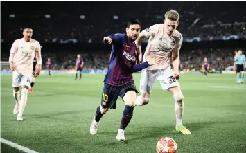  ??  ?? LIONEL MESSI is closely marked by Scott McTominay at the Nou Camp on Tuesday.