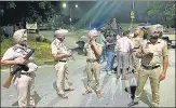  ?? KESHAV SINGH/HT PHOTO ?? Punjab Police personnel cordon off the area after a blast in Mohali on Monday.
