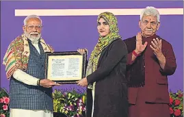  ?? WASEEM ANDRABI /HT ?? Prime Minister Narendra Modi hands over an appointmen­t letter to new recruit during a public rally at the Maulana Azad Stadium in Jammu on Tuesday.