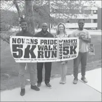  ?? Joseph B. Nadeau/The Call ?? From left, Marcus Harmon, Carnell Henderson, Carol Nasuti and Corey Brown hold up signs for the annual Novans Pride 5K.
