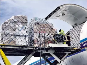  ?? Richard Vogel Associated Press ?? PALLETS of personal protective equipment arrive from China at LAX. Gov. Gavin Newsom says the state’s contract with BYD calls for 150 million N95 masks to be delivered to California this month and next.