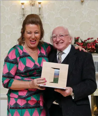  ??  ?? GOAL programme manager Mary T Murphy, Reenaree, receiving the The Presidenti­al Distinguis­hed Service Award for the Irish Abroad from President Michael D Higgins at Árus an Uactarán