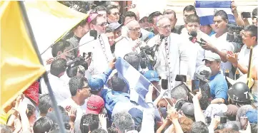  ??  ?? Baez speaks next to Cardinal Leopoldo Jose Brenes (centre) and Papal Nuncio Stanislaw Waldemar Sommertag (left) upon arrival in Masaya, Nicaragua. — AFP photo