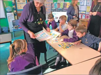  ??  ?? Kilmory Primary pupils take part in fun activities while enjoying a nibble of Fairtrade chocolate.