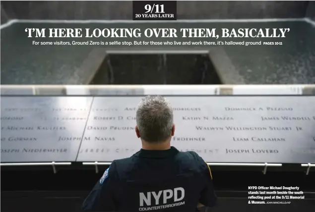  ?? JOHN MINCHILLO/AP ?? NYPD Officer Michael Dougherty stands last month beside the south reflecting pool at the 9/11 Memorial & Museum.