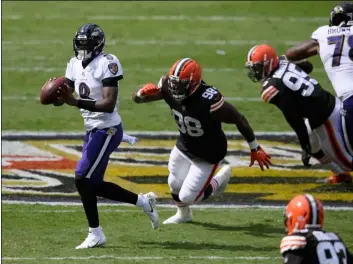  ?? AP Photo/Nick Was ?? Baltimore Ravens quarterbac­k Lamar Jackson (8) looks to pass as he is pursued by Cleveland Browns defensive tackle Sheldon Richardson (98), during the first half of an NFL football game, on Sept. 13 in Baltimore, MD.