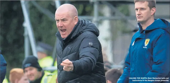  ??  ?? CALLING THE SHOTS: Mark Warburton belts outinstruc­tions to his Rangers troops yesterday