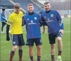  ??  ?? Scotland teammates Lewis Cameron and Scott Maitland share some banter with Wishaw’s Lee Hadden, centre, during a Scotland training session at Falkirk Stadium last Sunday.