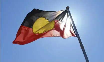  ?? Photograph: Lukas Coch/AAP ?? A Senate inquiry has found the compulsory acquisitio­n of the copyright of the Aboriginal flag would perpetuate the dispossess­ion and injustice endured by Aboriginal people.