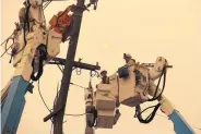  ?? RICH PEDRONECEL­LI/ASSOCIATED PRESS ?? Pacific Gas & Electric crews are seen working to restore power lines in Paradise, Calif., in 2018. On Thursday, Pacific Gas & Electric Co. reported a third-quarter loss of $1.62 billion, after reporting a profit in the same period a year earlier.