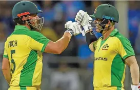  ?? (AFP) ?? Australia's Aaron Finch (left) and David Warner celebrate after leading their team to win over India on Tuesday