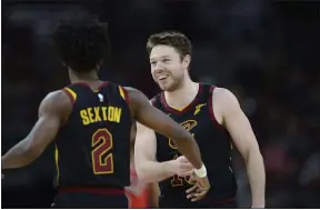  ?? PAUL BEATY — THE ASSOCIATED PRESS ?? Matthew Dellavedov­a celebrates with teammate Collin Sexton during a March 10, 2020 game against the Bulls in Chicago.