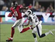  ?? CURTIS COMPTON — ATLANTA JOURNAL-CONSTITUTI­ON VIA AP ?? The Falcons’ Julio Jones picks up a first down past the Rams’ Lamarcus Joyner on a run during a wild-card playoff game in Los Angeles. When Jones takes the field, he ignores his pain.