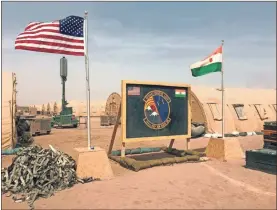  ?? Ap-carley Petesch, File ?? In this file photo taken Monday, April 16, 2018, a U.S. and Niger flag are raised side by side at the base camp for air forces and other personnel supporting the constructi­on of Niger Air Base 201 in Agadez, Niger.